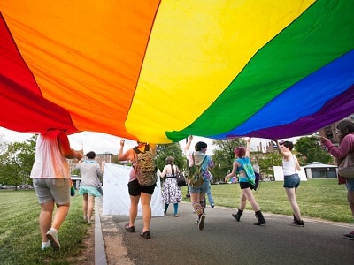 Teens with a rainbow flag.