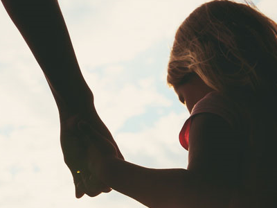 A person holding hands with a child