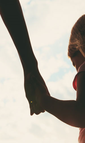 A person holding hands with a child