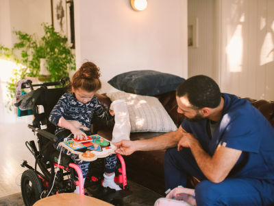 A kid in a wheelchair playing with a puzzle