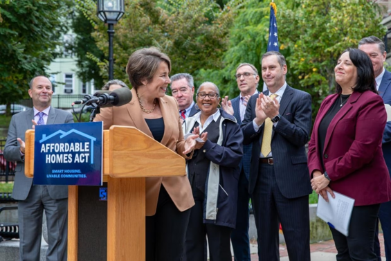 Governor greeting people at the signing of the Affordable Homes Act