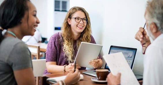 A female with colleagues smiling
