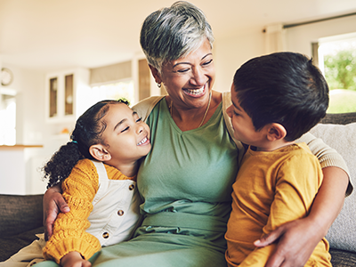 A grandma embraces her two grandchildren