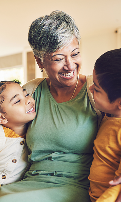 A grandma embraces her two grandchildren