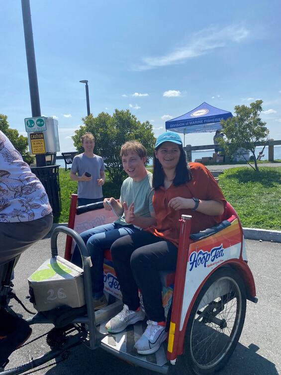 Tatiana Thomas and Austin and Andrew Carr riding in a pedicab.